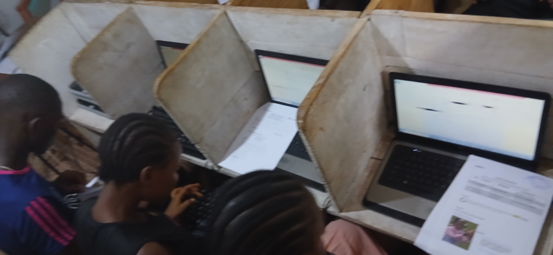 Overhead view of laptops open on Microsoft Publisher documents in study booths